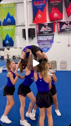 a group of young women standing on top of each other