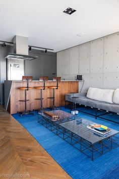 a living room filled with furniture and a blue rug