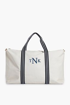 White and Navy Coated Canvas Weekender Classic Rectangular Vacation Bag, Classic Summer Vacation Bags, Luxury Leather Trim Bags For Vacation, Elegant Weekend Tote Duffle Bag, Elegant Weekender Tote Bag For Weekend Trips, Elegant Tote Weekender Bag For Weekend Trips, Elegant Tote Weekender Bag, Chic Tote Bag For Weekend Trips, Elegant Tote Duffle Bag For Weekend Trips