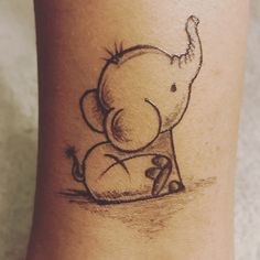 an elephant tattoo on the leg of a woman's foot, which is drawn in black ink