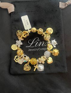 a close up of a bracelet on a black cloth with the name lin jewelry company