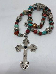 "This piece is so beautiful. It is a genuine, vintage, Taxco multi stone and sterling silver cross necklace. The necklace is 22 inches. The necklace features gorgeous, natural blue turquoise, red coral, carnelian, black onyx and sterling silver beads with a huge stamped sterling silver and black onyx cross. The stones are nuggets, round beads, rondelle beads. The sterling silver beads are stunning with etchings, including flowers, scrollwork, ribbed and other designs; some beads are shaped like Bohemian Turquoise Cross Necklace, Bohemian Cross Pendant Necklaces For Jewelry Making, Bohemian Cross Pendant Jewelry, Spiritual Turquoise Necklace With Cross Pendant Gift, Spiritual Turquoise Cross Pendant Necklace Gift, Bohemian Turquoise Cross Pendant Necklace, Artisan Cross Necklace For Jewelry Making, Spiritual Cross Turquoise Necklace For Gift, Spiritual Turquoise Cross Necklace As Gift