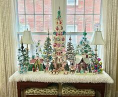 a christmas tree is displayed in front of a window