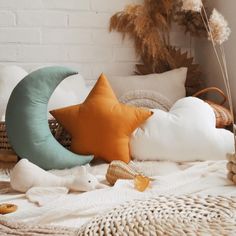 a bed topped with lots of pillows and blankets