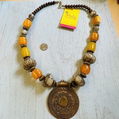 Get ready to add a pop of color to your outfit with this stunning Mela Chunky Glass Bead Brass Medallion Necklace. The necklace is made of high-quality brass metal and features a beautiful multicolor beaded design, making it a perfect accessory to wear on any occasion. With a 24-inch necklace length, it sits perfectly on your neck, giving you a comfortable and stylish look. Whether you're dressing up or down, this Mela necklace is sure to impress. Opalite Necklace, Shell Beads Necklace, Antique Jewelry Necklace, Blue Beaded Necklace, Fairy Necklace, Charm Necklace Silver, Medallion Necklace, Purple Rhinestone, Brass Glass