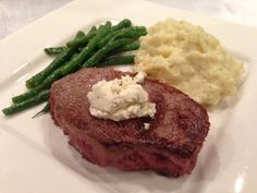 steak, mashed potatoes and green beans on a white plate