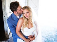 a bride and groom kissing in front of an open door