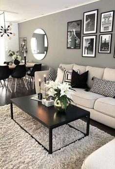 a living room filled with lots of furniture and pictures on the wall above it's coffee table