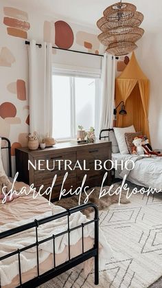 two beds in a bedroom with neutral boho wallpaper and rugs on the floor