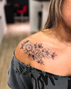 a woman with a flower tattoo on her shoulder