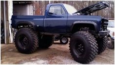 a large blue truck parked in front of a building