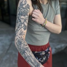 a woman with a flower tattoo on her arm