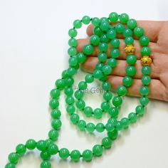 "DESCRIPTION: Thank you for coming in! Breath-taking imperial chrysoprase bead necklace with rare sphere stones and 18k solid gold granulation spacers, 423 carats of mesmerizing glowing green material! Extremely rare and precious! 36\" long Lariate necklace! You'll get the necklace you see! SIZE: 8mm-9.2mm MATERIAL: 18k solid gold, Imperial Chrysoprase(Australian Origin)" Chrysoprase Gemstone Jewelry With Round Beads, Spiritual Round Chalcedony Bead Jewelry, Healing Single Strand Round Bead Gemstones, Jade Emerald Necklace With Round Beads For Healing, Elegant 8mm Round Beads For Gems And Cabochons, Green Onyx Round Beads Jewelry, Green Onyx Gemstone Beaded Necklaces With Round Beads, Green Onyx Gemstone Beaded Necklace With Round Beads, Green Gemstone Beads Jewelry For Formal Occasions