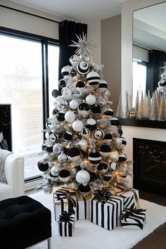 a white christmas tree with black and silver ornaments