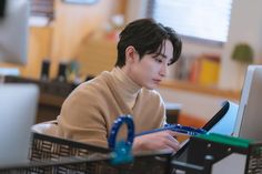 a person sitting at a desk with a laptop