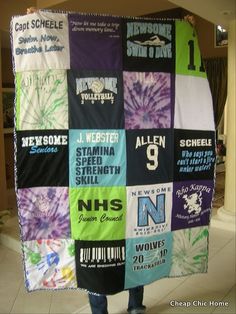 a man is standing in front of a large quilt