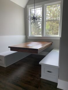 an empty room with a wooden table and bench