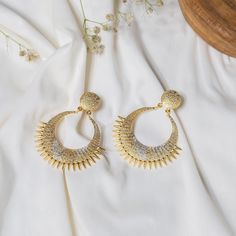 Define beauty and elegance with these Unique and Designer Handmade Gold & Silver Dangle Earrings. The earrings are finely crafted with a round stud and an ethnic dangler. The earrings are plated in dual-tone (gold and silver) and have a beautiful texture. These are just perfect for any special occasion or a happy day! Details: Brass Metal Gold & Silver Plating Handmade Dangle/Drop Earrings Ethnic Earrings Hypoallergenic Nickel & Lead-free Metal Earrings With Elegant Design For Anniversary, Elegant Metal Earrings For Anniversary, Elegant Metal Chandbali Bridal Earrings, Elegant Chandbali Bridal Earrings In Metal, Pierced Drop Bridal Earrings For Festive Occasions, Elegant Festive Dangle Hoop Earrings, Elegant Festive Hoop Earrings, Elegant Metal Chandbali Chandelier Earrings, Elegant Chandbali Metal Chandelier Earrings