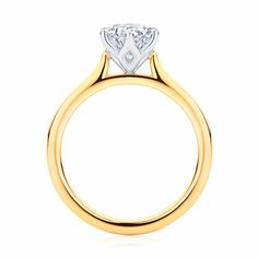 a yellow gold engagement ring with a single diamond