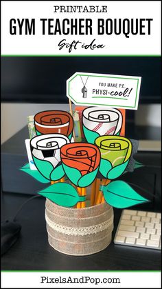 a vase filled with flowers sitting on top of a desk