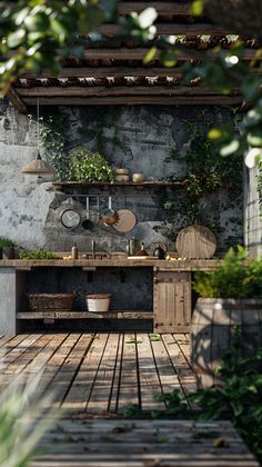 an outdoor kitchen with pots and pans on the counter, surrounded by greenery