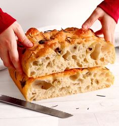 two pieces of bread being held by someone's hands over the top of it