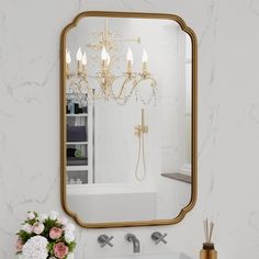 a bathroom with a sink, mirror and chandelier in the middle of it