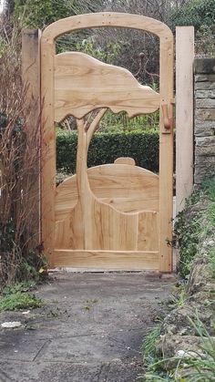 a wooden gate with a tree carved into it