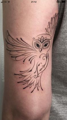 an owl tattoo on the arm