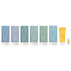 the skin care products are lined up on a white surface, with different shades of blue and yellow