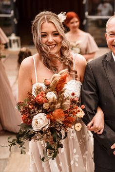 a bride and groom walking down the aisle