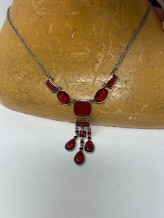 A sweet red bead choker necklace. with metal links. Nice shapes which lead to three pieces to fall at throat. It's on a double chain to add to the appearance.  Suitable for all ages. It has a safe clasp. There is an extension chain as well to fit most. A nice dress up or costume piece. It measures 19 cm and extends to 27cm with extra chain long and is in good condition. The lovely drop of beads at the bottom is nearly 7cm. Very pretty. Piece of costume jewellery I am a trusted vintage dealer bas Red Jewelry With Lobster Clasp For Party, Red Party Jewelry With Lobster Clasp, Red Dangle Necklaces For Party, Red Metal Necklaces For Party, Red Choker Necklace With Lobster Clasp, Red Costume Jewelry Necklaces For Party, Red Metal Choker Jewelry, Vintage Red Choker Jewelry, Red Vintage Choker Jewelry