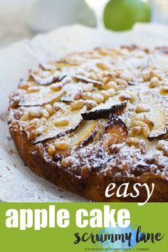 an easy apple cake is topped with powdered sugar