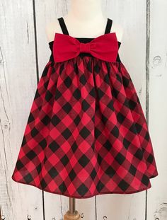 "This little dress is too cute with it's big Buffalo Plaid print in Black and Red which makes it perfect for Christmas or any time at all. You also have 2 bows to choose from. You can find the matching jon jon here: https://www.etsy.com/listing/894117396/red-and-black-plaid-jon-jon-baby-boy-jon?ref=shop I wash all my fabric in Tide with a Downy rinse and dry completely to reduce shrinkage. Approximate measurements are: Bodice Length (stretched) 6-12 months 22.5\" 13\" 12-18 months 23.5\" 16\" 2 Black Check Dress, Pooh Dress, Big Bow Dress, Christmas Dress Baby, Red Christmas Dress, Buffalo Check Christmas, Girls Holiday, Jon Jon, Minnie Mouse Dress