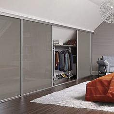 a bedroom with an orange bed and white closets