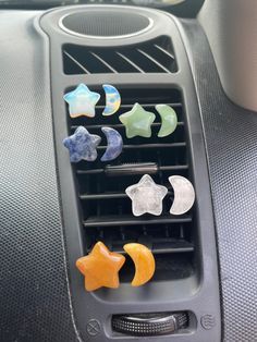 an air vent in the middle of a car filled with different colored stars and crescents