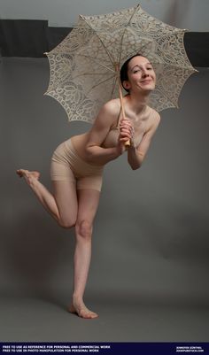 a naked woman holding an umbrella and posing for the camera with it's legs spread out