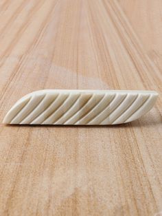 a white object sitting on top of a wooden table