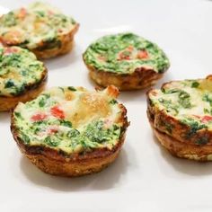 mini quiches filled with spinach and cheese on a white plate, ready to be eaten