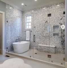 a white bath tub sitting inside of a bathroom next to a walk - in shower