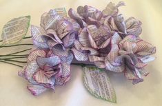 a bouquet of flowers made out of old book pages