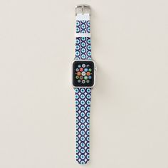 an apple watch is displayed on a white surface with blue and green circles around it