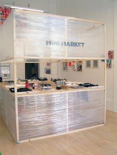 an office with plastic covering the counter and shelves on each side that says mini market