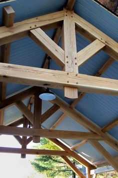 the inside of a building with wooden beams