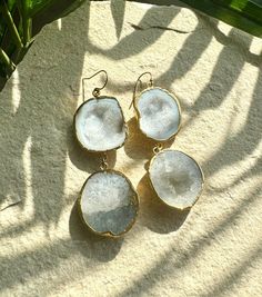 Discover the raw beauty of nature with these stunning white geode earrings. Each piece features a naturally unique geode stone, showcasing a sparkling crystal quartz center that add a touch of elegance to any outfit. Perfect for both casual and formal occasions, these earrings are a versatile addition to your jewelry collection. 3" Long 14k Gold-filled Earring Hooks Elegant Raw Jewelry For Gifts, White Agate Wedding Jewelry, Bohemian White Earrings With Natural Stones, White Natural Stone Wedding Earrings, Elegant Raw Jewelry Gift, White Earrings With Natural Stones For Gift, White Natural Stones Earrings For Wedding, White Drop Earrings With Natural Stones, White Crystal Gemstone Drop Earrings