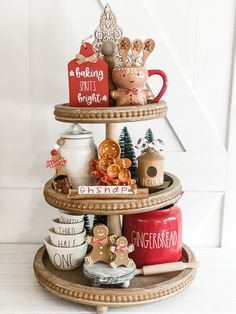 three tiered tray with christmas decorations and cookies on it's sides, along with other items