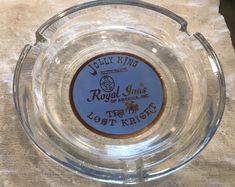 an empty glass bowl with the label jelly king on it's side, sitting on a white towel