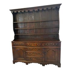 an old fashioned wooden dresser with drawers and cupboards on the front, against a white background