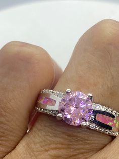 Unusual pale pink ice CZ and pink opal inlay. Deco sterling setting handmade Size 7 Can be resized. My jeweler charges $10-$20 All rings are shipped in a nice gift box. Check out our over a THOUSAND great reviews Engraving is $4 per letter and is not always perfect depending on the piece. It can take a few days if the jeweler is busy. This is payable to Paypal Judithsltd@gmail.com Pink Round Jewelry With Accent Stones, Pink Jewelry With Round Accent Stones, Pink Round Stone Promise Ring, Pink Opal Rings With Gemstone, Pink Sterling Silver Rings With Accent Stones, Pink Jewelry With Accent Stones, Pink Opal Gemstone Rings, Pink Sterling Silver Opal Ring For Anniversary, Pink Opal Ring With Accent Stones As Gift