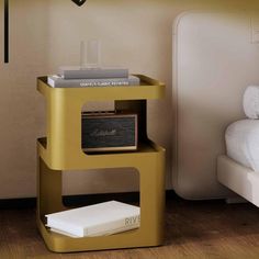 a nightstand with a radio on it next to a bed